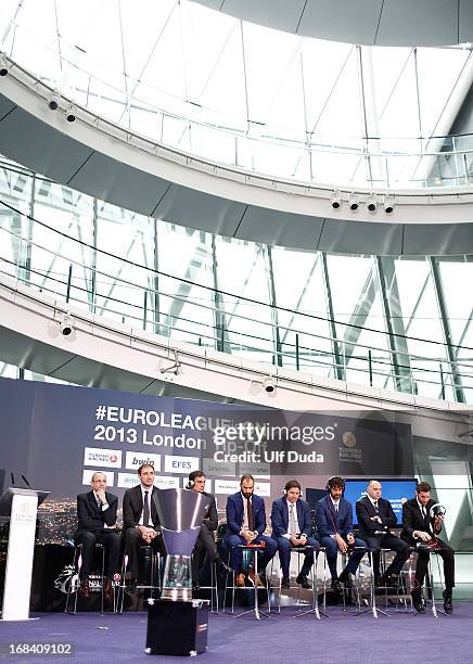 Coaches and players pose with the Champions Trophy at the end of the Turkish Airlines EuroLeague Final Four Presentation Press Conference at London...