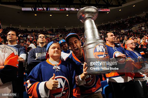 Fans prepare for the game during warm ups between the New York Islanders and the Pittsburgh Penguins in Game Three of the Eastern Conference...