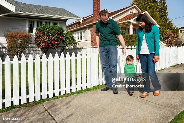 young family taking a stroll - small town community stock pictures, royalty-free photos & images