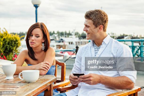 annoying boyfriend with smart phone - bad romance stock pictures, royalty-free photos & images