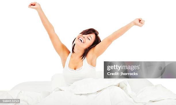 rise and shine: morgen-stretching - bed on white background stock-fotos und bilder