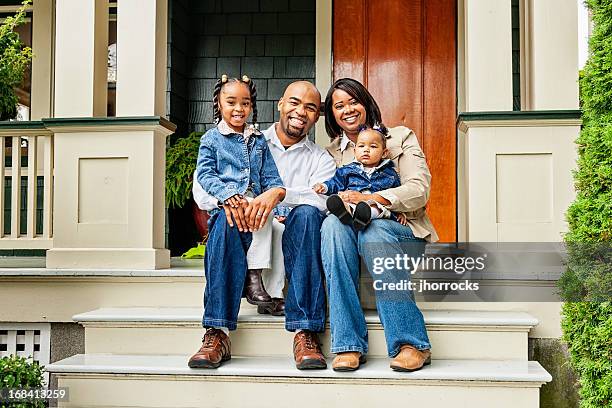 happy family on front porch - family of four in front of house stock pictures, royalty-free photos & images