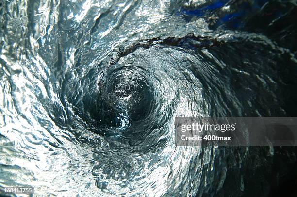 illuminated blue water vortex - flushing stock pictures, royalty-free photos & images