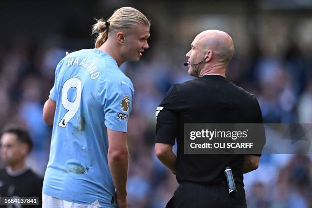 Manchester City's Norwegian striker Erling Haaland speaks with English referee Anthony Taylor after the English Premier League football match between...