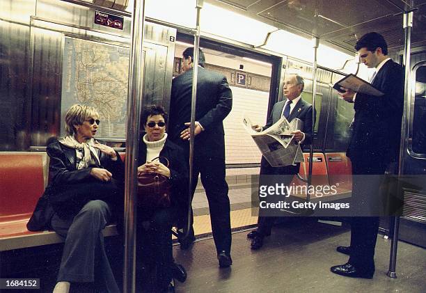 New York City Mayor Michael Bloomberg, center, rides to City Hall on the R train after an NYPD swearing-in ceremony at Madison Square Garden March...