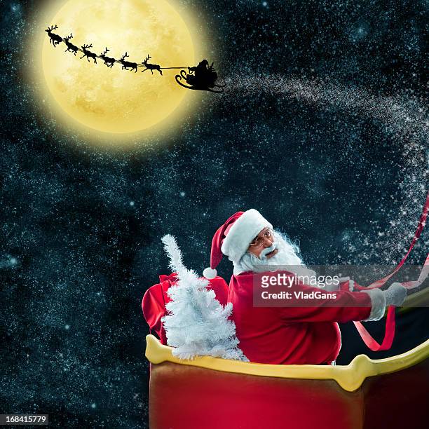 santa claus in his deer sled near the moon - papa noel stock pictures, royalty-free photos & images