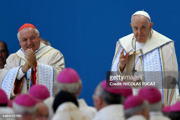 The Archbishop of Marseilles Jean-Marc Aveline greets Pope Francis during a mass inside the Velodrome stadium, in the southern port city of Marseille...