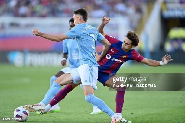 Barcelona's Portuguese forward Joao Felix fights for the ball with Celta Vigo's Spanish defender Oscar Mingueza during the Spanish Liga football...