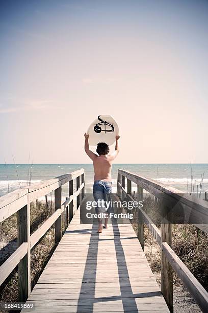 surfer boy - outer banks stock pictures, royalty-free photos & images