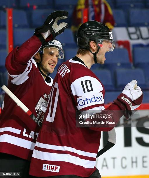 Lauris Darzins of Latvia celebrate with team mate Krisjanis Redlihs after he scores his team's 5th goal during the IIHF World Championship group H...