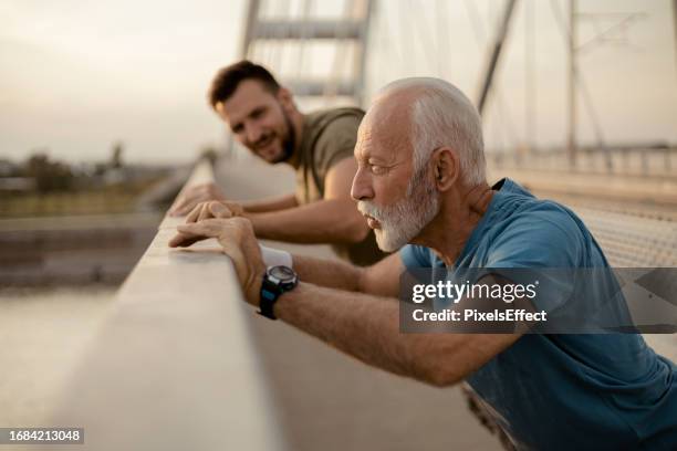 senior father and his adult son doing exercise and workout - grandpa son stock pictures, royalty-free photos & images