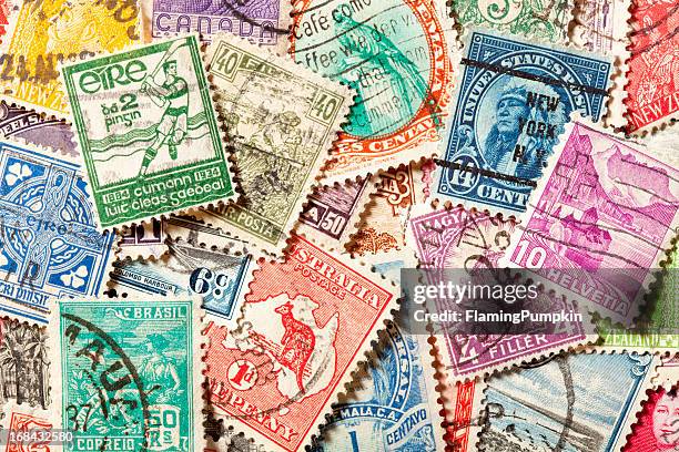 background of old, canceled postage stamps. xxxl - postage stamp stock pictures, royalty-free photos & images