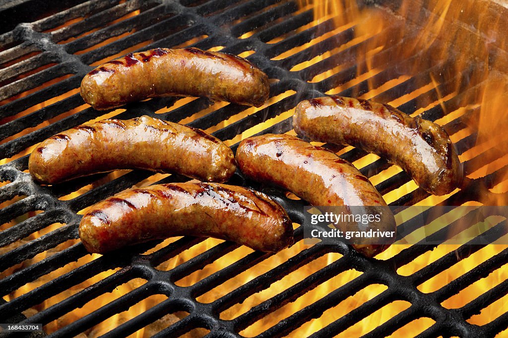 Bratwurst or Hot Dogs on Grill with Flames