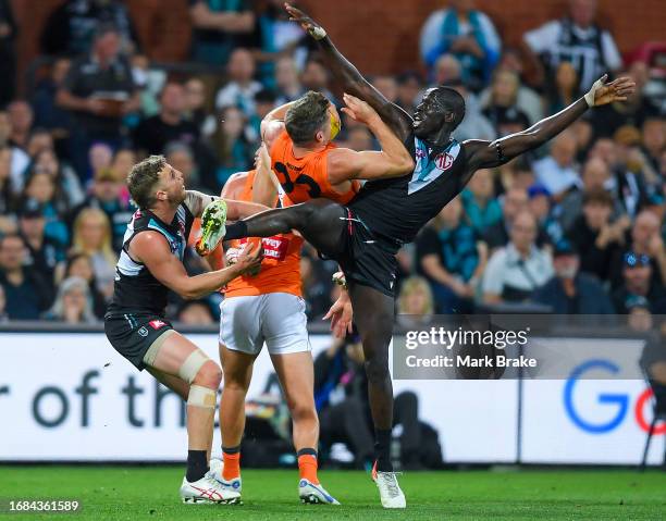 Jesse Hogan of the Giants marks over Trent McKenzie and Aliir Aliir of Port Adelaide during the AFL Second Semi Final match between Port Adelaide...