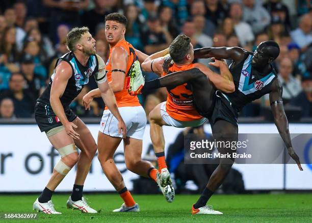 Jesse Hogan of the Giants marks over Trent McKenzie and Aliir Aliir of Port Adelaide during the AFL Second Semi Final match between Port Adelaide...