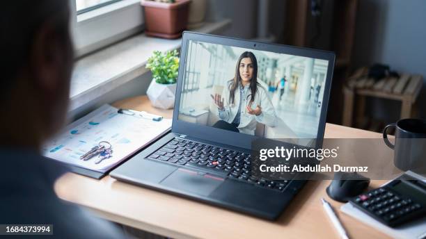 businessman having online conversation with doctor in office - press conference cameras stock pictures, royalty-free photos & images