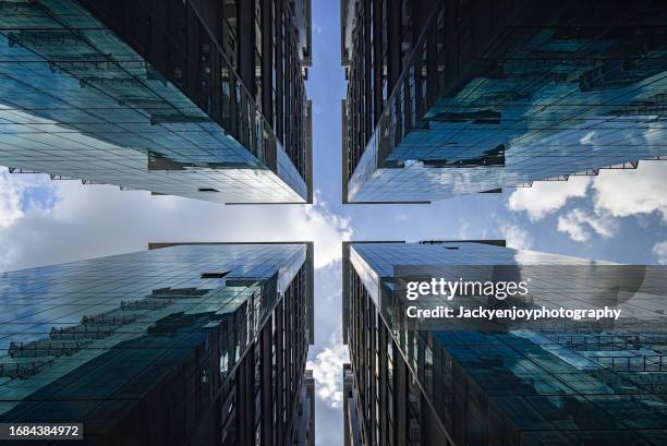 low-angle image of an office building - capitalism stock pictures, royalty-free photos & images