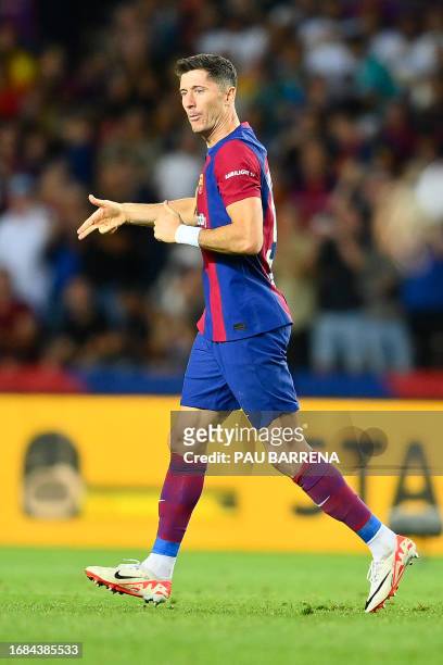 Barcelona's Polish forward Robert Lewandowski celebrates after scoring his team's first goal during the Spanish Liga football match between FC...