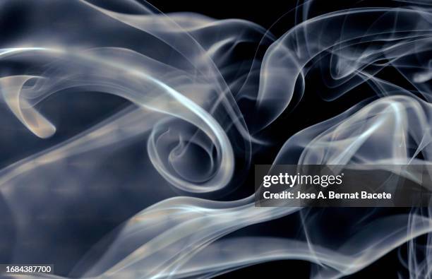 soft trails of moving white smoke on a black background. - electronic cigarette smoke stockfoto's en -beelden