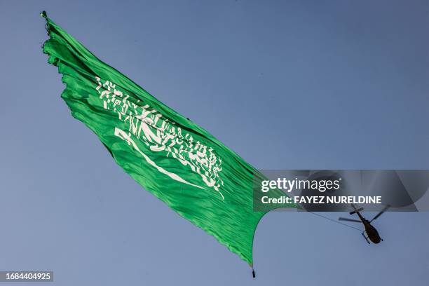 Helicopter flies over with a giant Saudi flag during an air show marking Saudi Arabia's 93rd National Day celebrations in Riyadh on September 23,...