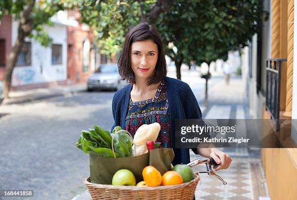 woman with bicycle basket full of fresh groceries - shopping with bike stock-fotos und bilder