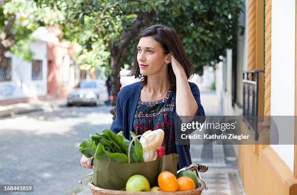 woman with bicycle basket full of fresh groceries - shopping with bike stock-fotos und bilder