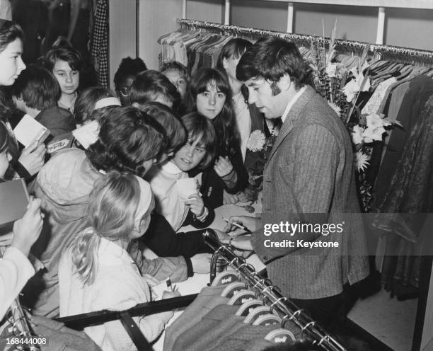 English comedian Jimmy Tarbuck surrounded by fans after he opened a Werff clothes shop in Hounslow, London, 1st October 1966.