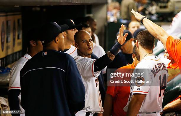 Ronny Cedeno of the Houston Astros celebrates with his teammates after scoring a run in the fifth inning against the Los Angeles Angels of Anaheim at...