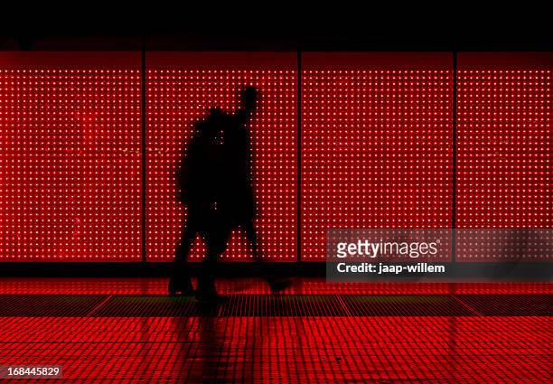 silhouette of man moving in red background - verlicht stockfoto's en -beelden
