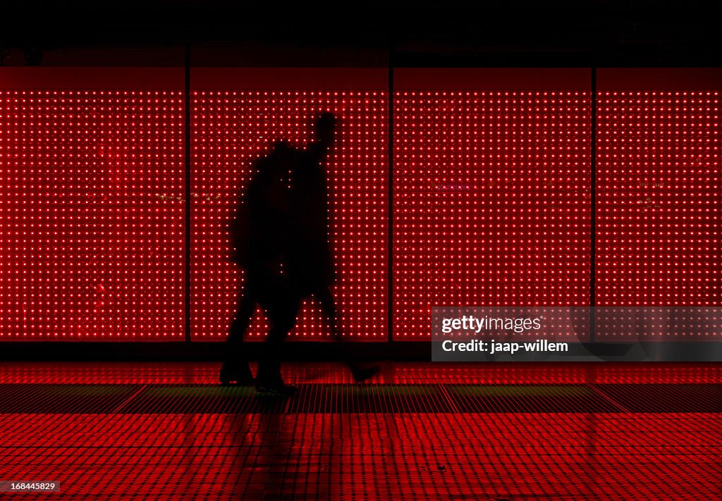 Silhouette of man moving in red background