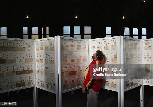 Stamp enthusiasts examine stamp collections on display at the World Stamp Expo on May 10, 2013 in Melbourne, Australia. The World Stamp Expo is the...