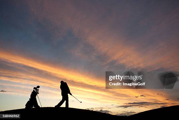 silhouette of male senior golfer swinging golf club - golf swing sunset stock pictures, royalty-free photos & images