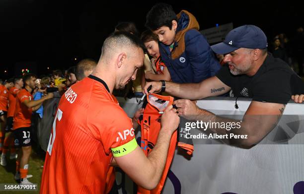 Tom Aldred of Brisbane signs autographs during the Australia Cup 2023 Quarter Final match between Brisbane Roar and Western Sydney Wanderers at Perry...