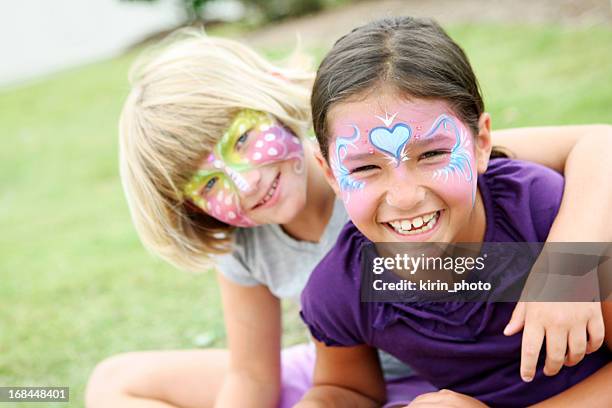 happy kids with painted faces wearing purple - ansiktsmålning bildbanksfoton och bilder