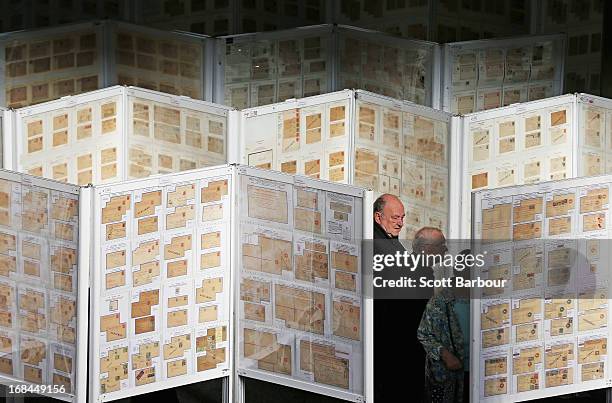 Stamp enthusiasts examine stamp collections on display at the World Stamp Expo on May 10, 2013 in Melbourne, Australia. The World Stamp Expo is the...