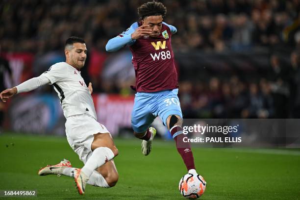 Manchester United's Portuguese defender Diogo Dalot fouls Burnley's US striker Luca Koleosho during the English Premier League football match between...