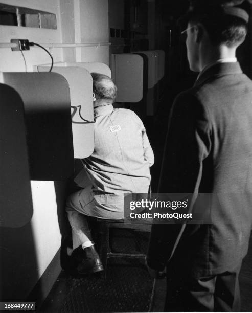 Alcatraz prisoner making a phone call, San Francisco, California, 1950s.