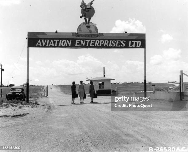 The symbol of the WASPs, 'Fifinella,' is on the sign above the gate where new trainees arrive at Avenger Field, Sweetwater, Texas, May 1944.