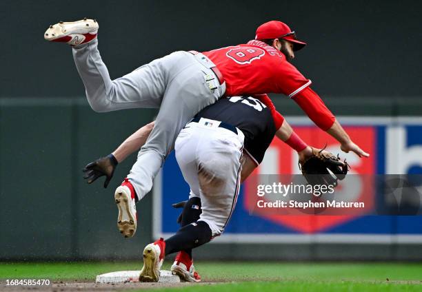 Andrew Stevenson of the Minnesota Twins collides with Michael Stefanic of the Los Angeles Angels as he throws to first base on a double play in the...