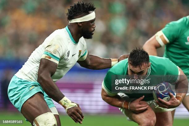 Ireland's hooker Ronan Kelleher challenges South Africa's blindside flanker Siya Kolisi during the France 2023 Rugby World Cup Pool B match between...