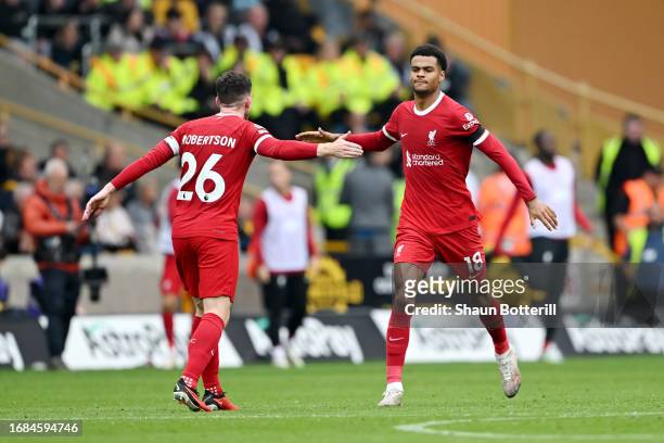 Cody Gakpo of Liverpool celebrates with team mate Andrew Robertson after scoring their sides first goal during the Premier League match between...