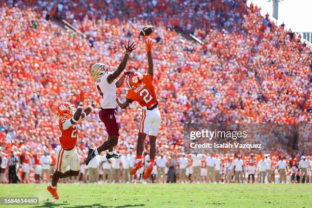 Keon Coleman of the Florida State Seminoles and Nate Wiggins of the Clemson Tigers compete for a catch late in the fourth quarter at Memorial Stadium...