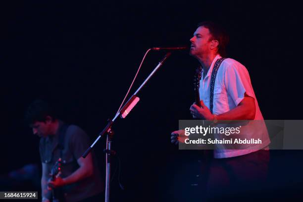 Caleb Followill and Matthew Followill of Kings of Leon perform at the Singapore Formula One Grand Prix at Marina Bay Street Circuit on September 16,...