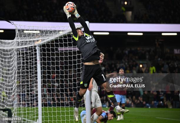 Burnley's English goalkeeper James Trafford claims the ball during the English Premier League football match between Burnley and Manchester United at...