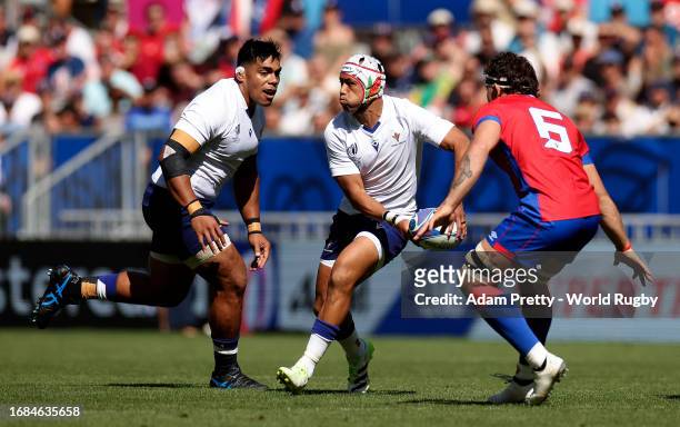Christian Leali'ifano of Samoa runs with the ball whilst under pressure from Santiago Pedrero of Chile during the Rugby World Cup France 2023 match...