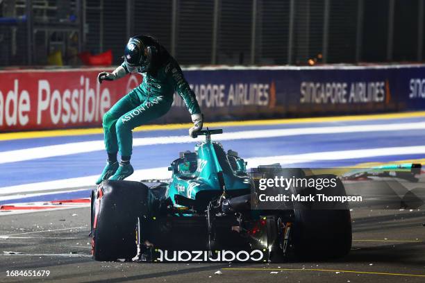 Lance Stroll of Canada and Aston Martin F1 Team climbs out of his car after crashing on track during qualifying ahead of the F1 Grand Prix of...