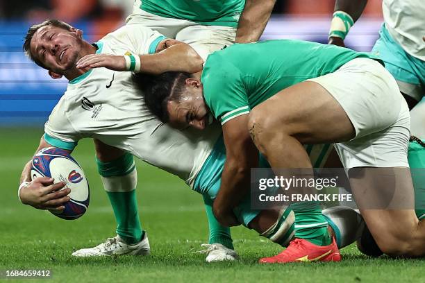 South Africa's flanker Kwagga Smith is tackled by Ireland's left wing James Lowe during the France 2023 Rugby World Cup Pool B match between South...