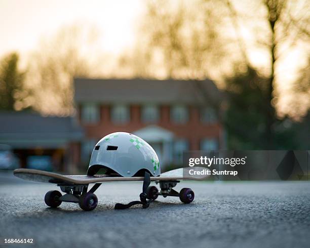 fun day! skateboard and helmet in suburban neighborhood - skating helmet stock pictures, royalty-free photos & images