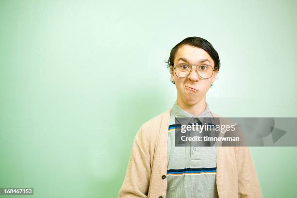teenage nerdy guy with green wall copy space - nerd sweater stock pictures, royalty-free photos & images