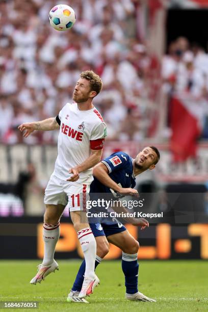 Florian Kainz of Koeln and Andre Kramaric of Hoffenheim go up for a header during the Bundesliga match between 1. FC Köln and TSG Hoffenheim at...